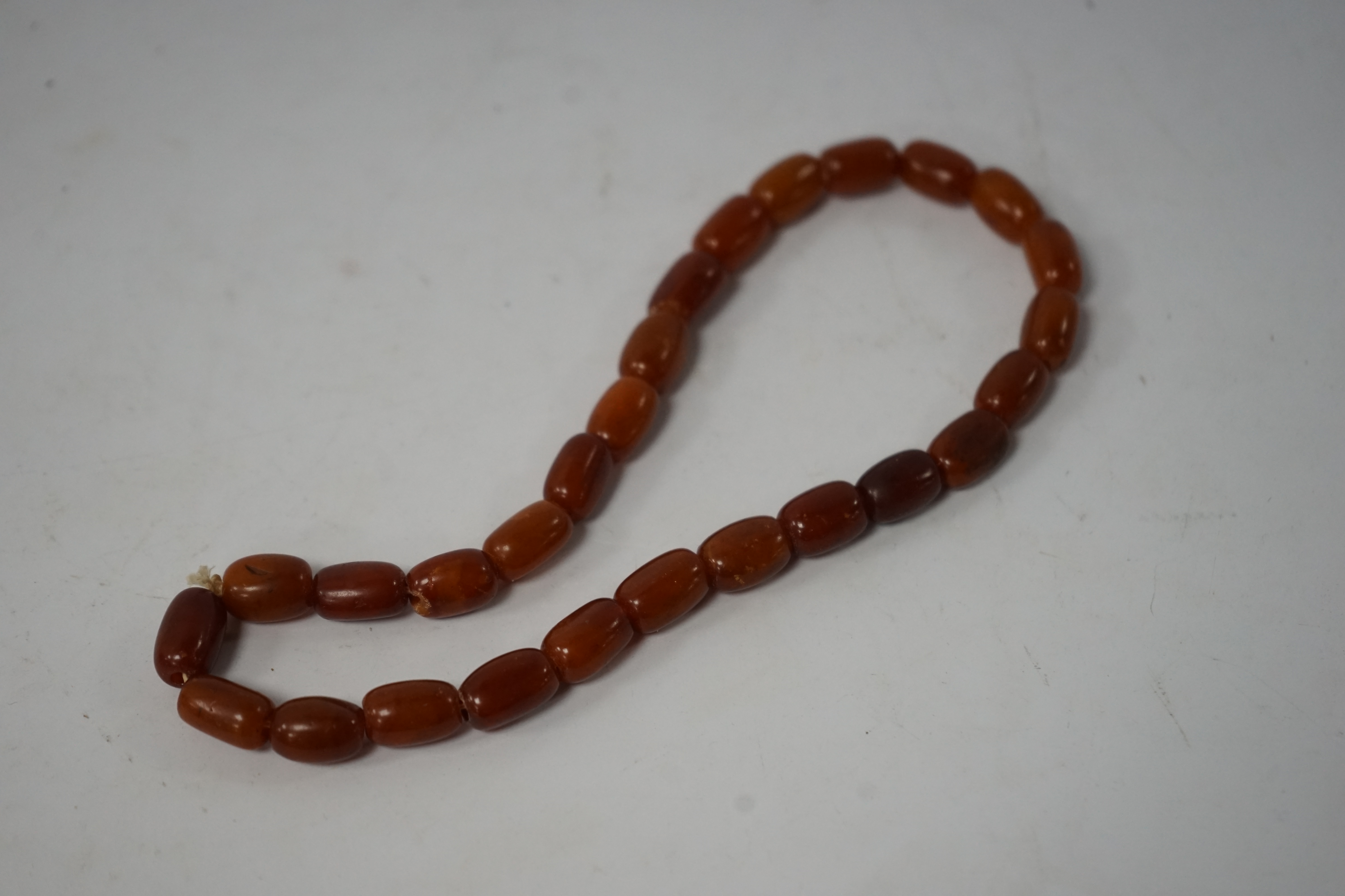 A single strand amber bead necklace, 34cm, gross weight 20 grams. Condition - poor to fair